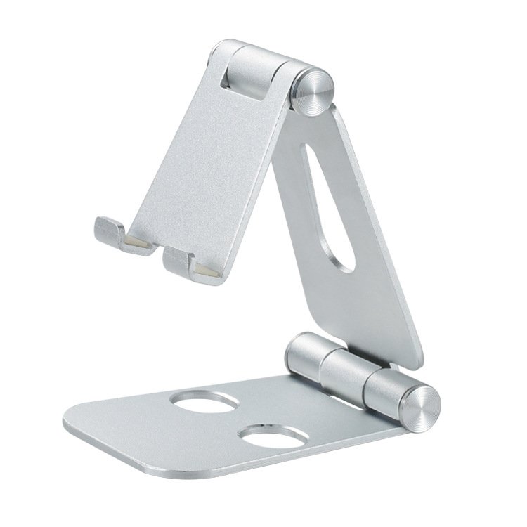 Aluminum desk stand holding a phone beside a mechanical keyboard